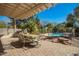 Inviting backyard patio with shade and a lovely view of the sparkling backyard pool at 2467 E Page Ave, Gilbert, AZ 85234