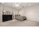 Bedroom featuring carpet, ceiling fan, and ensuite bathroom at 2467 E Page Ave, Gilbert, AZ 85234