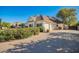 Paver driveway leading to a home with an attached garage, surrounded by mature trees and landscaping at 2467 E Page Ave, Gilbert, AZ 85234