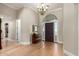 Elegant foyer with hardwood floors, a decorative mirror, and a chandelier, creating a welcoming entrance at 2467 E Page Ave, Gilbert, AZ 85234