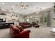 Bright living room with a ceiling fan and large windows, adjacent to a spacious kitchen with marble countertops at 2467 E Page Ave, Gilbert, AZ 85234