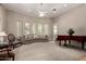 Spacious living room with neutral carpeting, large windows, and a grand piano creating an elegant ambiance at 2467 E Page Ave, Gilbert, AZ 85234