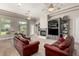 Spacious living room featuring large windows with backyard views, fireplace, and media center at 2467 E Page Ave, Gilbert, AZ 85234