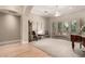 Bright and airy living room with light hardwood floors, neutral carpet, and a grand piano at 2467 E Page Ave, Gilbert, AZ 85234