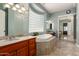 Luxurious main bathroom with a soaking tub, double vanity, and elegant tile work at 2467 E Page Ave, Gilbert, AZ 85234