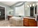 Elegant main bathroom with a soaking tub, dual sinks, and stylish cabinetry at 2467 E Page Ave, Gilbert, AZ 85234