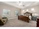 Serene main bedroom with a decorative bed frame, neutral color scheme, and ample natural light at 2467 E Page Ave, Gilbert, AZ 85234