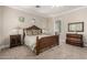 Spacious main bedroom with a decorative bed frame, side tables, and a calming ambiance at 2467 E Page Ave, Gilbert, AZ 85234