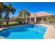 Inviting backyard pool with blue water, palm trees, and patio area perfect for outdoor entertaining at 2467 E Page Ave, Gilbert, AZ 85234