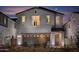 Two-story home showcasing a front-entry two-car garage and decorative brickwork at 2468 W Rowel Rd, Phoenix, AZ 85085