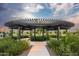 Walkway under a modern circular pergola with lush desert landscaping and beautiful sky at 2468 W Rowel Rd, Phoenix, AZ 85085