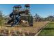 Rustic playground with mulch surface, surrounded by trees and grass at 2468 W Rowel Rd, Phoenix, AZ 85085