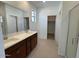 Bright bathroom with double sinks, granite countertops, and a glass enclosed shower at 25180 W Wayland Dr, Buckeye, AZ 85326