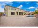 Exterior view of a two-story house with a pool, brick patio, and desert landscaping in the backyard at 2873 E Nolan Pl, Chandler, AZ 85249