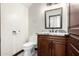 Stylish powder room featuring a dark wood vanity, granite countertop, and modern fixtures at 2873 E Nolan Pl, Chandler, AZ 85249