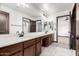 Bathroom featuring double sinks, stylish light fixtures and wood cabinets at 2873 E Nolan Pl, Chandler, AZ 85249