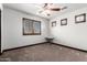 Bright bedroom featuring carpeted floors, a ceiling fan, and natural light from multiple windows at 2873 E Nolan Pl, Chandler, AZ 85249