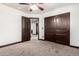 Bedroom showcasing carpeted floors, a ceiling fan, a closet with sliding doors and access to another room at 2873 E Nolan Pl, Chandler, AZ 85249