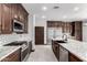 The kitchen features stainless steel appliances, a large center island and plenty of counter space at 2873 E Nolan Pl, Chandler, AZ 85249