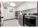 Laundry room featuring stainless steel appliances, shelves and tile flooring at 2873 E Nolan Pl, Chandler, AZ 85249