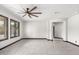 Open-concept living room with tile flooring, ceiling fan, and large window with wood shutters at 2873 E Nolan Pl, Chandler, AZ 85249