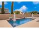 Backyard pool featuring patio umbrellas, decorative waterfalls, and surrounded by landscaping at 2873 E Nolan Pl, Chandler, AZ 85249