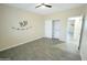 Neutral bedroom with wood look floors and closet with white sliding doors at 29810 W Bellview St, Buckeye, AZ 85396