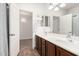 Bathroom showcasing double sinks, tile flooring, and a door to the bedroom at 29997 N 70Th Dr, Peoria, AZ 85383