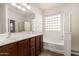 Bright bathroom features a double sink vanity, separate shower, and soaking tub with glass block window at 29997 N 70Th Dr, Peoria, AZ 85383