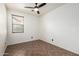 Neutral bedroom with a ceiling fan, tiled floor, and window with blinds at 29997 N 70Th Dr, Peoria, AZ 85383