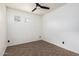 Bedroom featuring neutral colors, tiled flooring, a ceiling fan, and two windows at 29997 N 70Th Dr, Peoria, AZ 85383