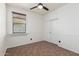 Bedroom featuring a fan, tiled floors, window with blinds, and a closet at 29997 N 70Th Dr, Peoria, AZ 85383