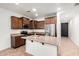 Kitchen featuring stainless steel appliances, an island with sink and ample wooden cabinets at 29997 N 70Th Dr, Peoria, AZ 85383