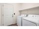 Laundry room area featuring a washer, dryer, and shelving above the units at 29997 N 70Th Dr, Peoria, AZ 85383