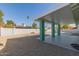 This backyard features a pool, patio, white brick privacy fence and desert landscaping at 3102 W Desert Cove Ave, Phoenix, AZ 85029