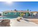 Beautiful backyard with a pristine pool, mature landscaping, and a covered patio, ideal for relaxation at 3102 W Desert Cove Ave, Phoenix, AZ 85029