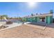 Expansive backyard featuring a refreshing pool, slide, and patio area, perfect for outdoor entertaining at 3102 W Desert Cove Ave, Phoenix, AZ 85029