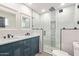 Renovated bathroom with double vanity, a walk-in shower and a toilet at 3102 W Desert Cove Ave, Phoenix, AZ 85029