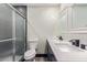 This bathroom features a double sink vanity and a shower with frosted doors at 3102 W Desert Cove Ave, Phoenix, AZ 85029