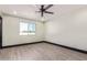 Well-lit bedroom with a ceiling fan, window, and light hardwood floors at 3102 W Desert Cove Ave, Phoenix, AZ 85029