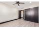 This bedroom features a ceiling fan, neutral walls, and a closet for ample storage at 3102 W Desert Cove Ave, Phoenix, AZ 85029