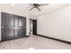 This bedroom features a ceiling fan, neutral walls, and a closet for ample storage at 3102 W Desert Cove Ave, Phoenix, AZ 85029