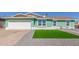 Charming single-Gathering home with a two-car garage, green grass and rock landscaping at 3102 W Desert Cove Ave, Phoenix, AZ 85029