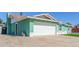 Side view of a charming home with a two-car garage and rock landscaping at 3102 W Desert Cove Ave, Phoenix, AZ 85029