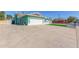 Side view of a charming home with a two-car garage and rock landscaping at 3102 W Desert Cove Ave, Phoenix, AZ 85029