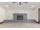 Bright living room featuring a gray brick fireplace and light hardwood floors at 3102 W Desert Cove Ave, Phoenix, AZ 85029