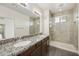 Bathroom featuring a large vanity, dual sinks, and a glass-enclosed shower at 33575 N Dove Lakes Dr # 2036, Cave Creek, AZ 85331