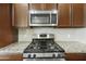 Close up on the gas range and tile backsplash in this kitchen at 33575 N Dove Lakes Dr # 2036, Cave Creek, AZ 85331