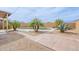 Backyard shows a pool and desert landscaping with mature trees and pavers at 35030 N Barzona Trl, San Tan Valley, AZ 85143