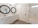 Bathroom features a double sink vanity with quartz countertop, decorative mirrors, and tub/shower combo at 35030 N Barzona Trl, San Tan Valley, AZ 85143